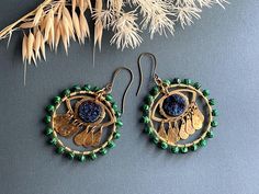 I'm thrilled to introduce you to these stunning handcrafted evil eye earrings--each pair is a true work of art. I've carefully combined tiny faceted green malachite beads, raw brass, and deep blue druzy coin beads to create a set that is both striking and meaningful. Each earring features a raw brass eye and dangling teardrops. These have been given a patina finish to add an earthy elegance and enhance the unique textures of the metal. The malachite beads have been meticulously hand wired to each brass hoop. The evil eye, a symbol of protection and good fortune, is deeply embedded in these earrings. Wearing them is not only a stylish choice but also a way to carry a piece of tradition that wards off negative energy and attracts positivity. I'm excited for you to experience the beauty and s Rustic Earrings, Evil Eye Earrings, Soft Toothbrush, Eye Earrings, Wire Wrapped Earrings, Brass Earrings, Raw Brass, Evil Eye, Druzy