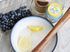 blueberries, lemons and honey sit on a table