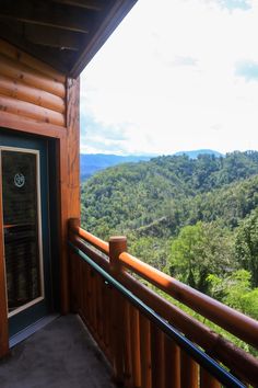 a balcony with wooden railings and mountain view