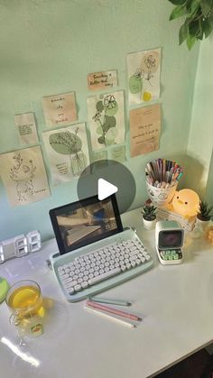 a laptop computer sitting on top of a white desk next to a keyboard and mouse