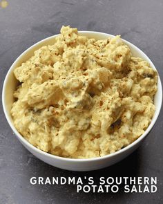 a white bowl filled with mashed potatoes on top of a black counter next to the words grandma's southern potato salad