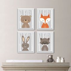 three pictures of animals on the wall above a crib with a teddy bear, fox, and raccoon