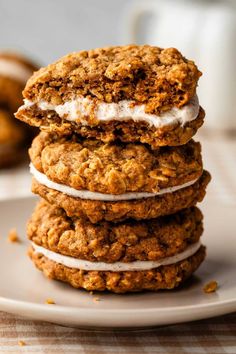 three oatmeal cookies stacked on top of each other with icing in the middle