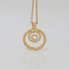 Hoop Design Pendant for modern women who appreciates high-quality craftsmanship. This stunning statement piece features an intricate design of concentric solid Circles with an exclusive texture. Perfect for minimalist jewelry lovers, this necklace is versatile enough to wear with any outfit, making it a timeless addition to your jewelry collection. Whether for a special occasion or to enhance everyday attire, this gold-plated pendant is the perfect accessory to exude confidence and enhance your Organic Pendant, Fashion Texture, Suede Jewelry, Exude Confidence, Hoop Design, Pendant For Women, 18k Gold Jewelry, Outfit Making, Exclusive Jewelry