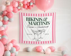 pink and grey balloons surrounding a sign that reads bikinis & martinis