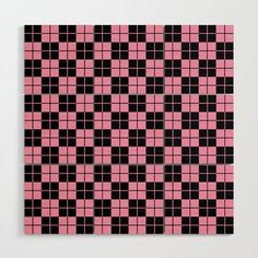 a pink and black checkered pattern on a white wall