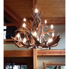 a deer antler chandelier hangs from the ceiling