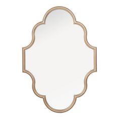 a gold framed mirror on a white wall