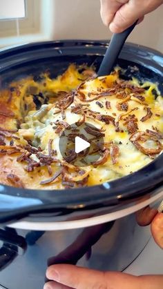 someone is using a spatula to stir food in a slow cooker