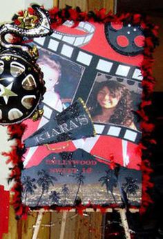 a red and black photo frame with some decorations on it's side, next to a pair of scissors