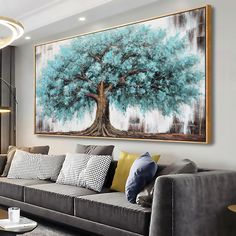 a living room filled with furniture and a large painting hanging on the wall above it