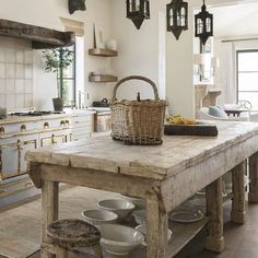 a large wooden table sitting in the middle of a kitchen