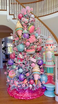 a decorated christmas tree with pink and blue ornaments