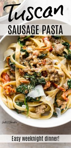 a white bowl filled with sausage and spinach pasta