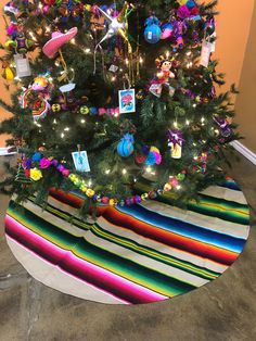 a brightly colored christmas tree with decorations on it