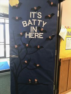 a door decorated with bats and the words it's batty in here