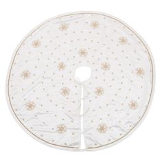 a round white table cloth with gold stars and circles on the top, in front of a white background