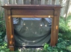 an old wooden fireplace with a tarp covering it