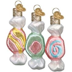 three glass candy ornaments in different colors and designs on each ornament are shown