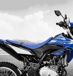 a blue and white motorcycle parked on the street