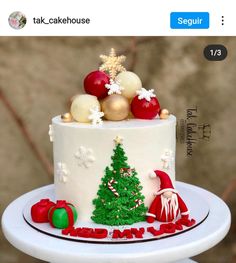 a cake decorated with christmas decorations on top of a table