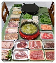 an assortment of meats and vegetables on a table