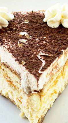 a piece of cake on a white plate with chocolate and cream frosting in the middle