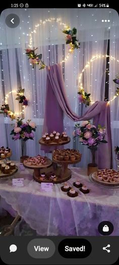 a table topped with cakes and cupcakes on top of a white table cloth