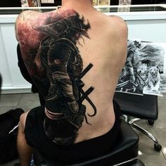 a man with a samurai tattoo on his back