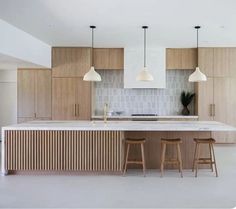 a kitchen with wooden cabinets and stools