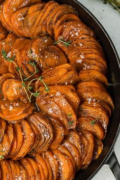 a pan filled with cooked sweet potatoes covered in gravy