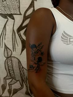 a woman with a flower tattoo on her left arm and right arm behind her back