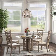 a dining room table with chairs and a rug