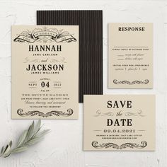 the wedding stationery is set up on a white wall