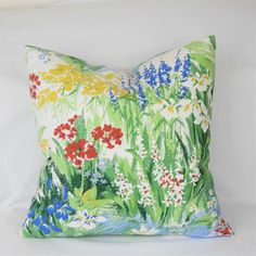 a colorful floral pillow on a white background