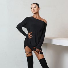 a woman is posing with her hands on her hips wearing thigh high stockings and knee high boots