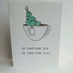 a card with a christmas tree in a tea cup