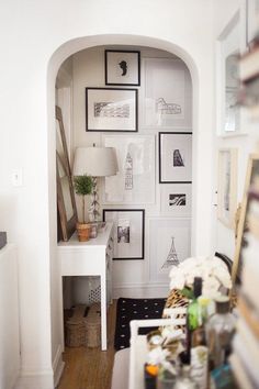 a room with pictures on the wall and a desk