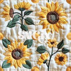 a quilt with sunflowers and leaves on it