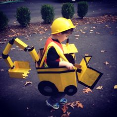 a little boy dressed up as a construction worker