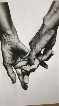 black and white photograph of two hands holding each other