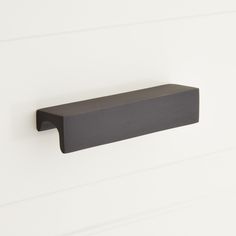 a black shelf mounted to the side of a wall