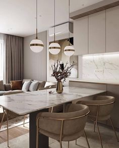 an elegant dining room with marble countertops and gold pendant lights hanging from the ceiling