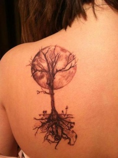 a woman with a tree tattoo on her back