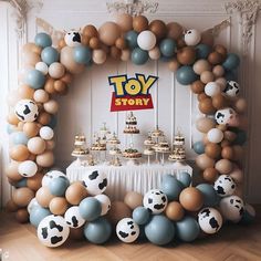 a toy story themed birthday party with balloons and desserts in the shape of soccer balls