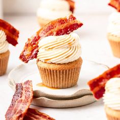 cupcakes with bacon on top and white frosting