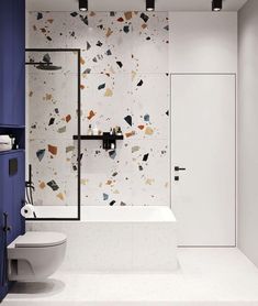 a bathroom with a toilet, sink and bathtub next to a wall mounted shower head