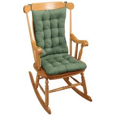 a wooden rocking chair with a green cushion on it's back and seat pad