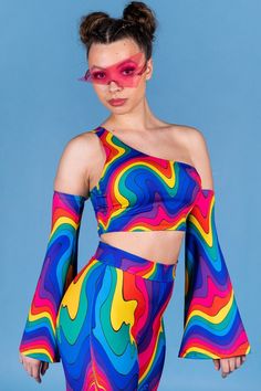 "Dive into a mesmerizing array of colors with this captivating one-shoulder crop top that perfectly embodies the beauty of rainbows. The stunning graphical spectrum patterns adorn this ensemble, creating a dynamic and energetic vibe. With its avant-garde design and contemporary aesthetic, this outfit ensures that all eyes will be on you. Embrace the dawn of a new era and let your radiance shine. And the best part? It's part of a spellbinding matching set that completes your sensational look, adding an extra touch of allure and charm. Embrace the power of matching pieces and elevate your style to new heights! > The set glows in the dark if a strong U.V. light is near it. ► Material & Washing The outfit is made of high-quality four-way stretch Italian Lycra® that consists of 80% Polyester an Rainbow Crop Top, Rave Tops, Crop Tops For Women, Outfit Festival, One Shoulder Crop Top, Rave Accessories, Rave Outfit, Neue Outfits, Women Plus Size