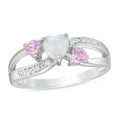 Capture her heart with the shimmering look of this three-stone fashion ring. Crafted in sterling silver, this darling design features a 5.0mm heart-shaped lab-created iridescent opal flanked by 3.0mm heart-shaped lab-created pink sapphires. Along the split shank, ribbons of diamond accents lend sparkle to the style. Proclaiming your love, this pretty choice is polished to a bright shine. Custom-made to fit her ring size. Sterling silver rings cannot be resized after purchase. Silver Diamond Jewelry, Her Ring, Handmade Gold Jewellery, Fine Silver Jewelry, Silver Jewelry Design, Black Hills Gold, Three Stone Ring, Silver Jewelry Rings, Lovely Ring